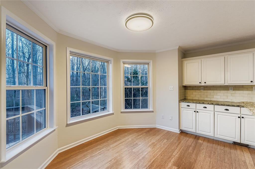 16 Inland Point Newnan, GA 30263 - Photo 5 of 34 a view of an empty room with a window and wooden floor