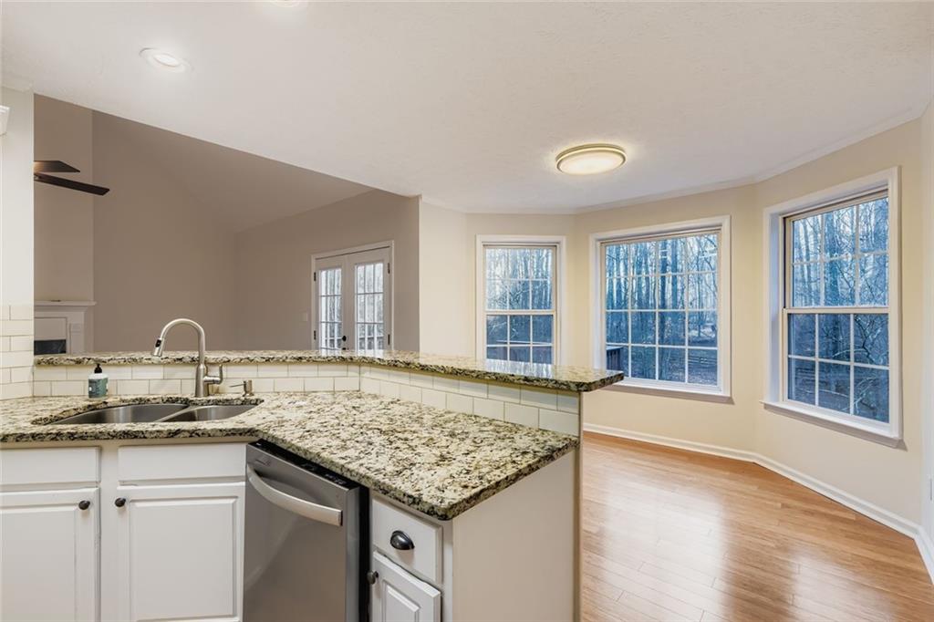 16 Inland Point Newnan, GA 30263 - Photo 6 of 34 a kitchen with a stove a sink cabinets and wooden floor