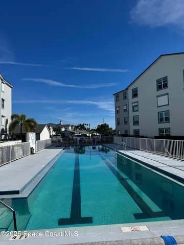 a swimming pool with outdoor seating and yard