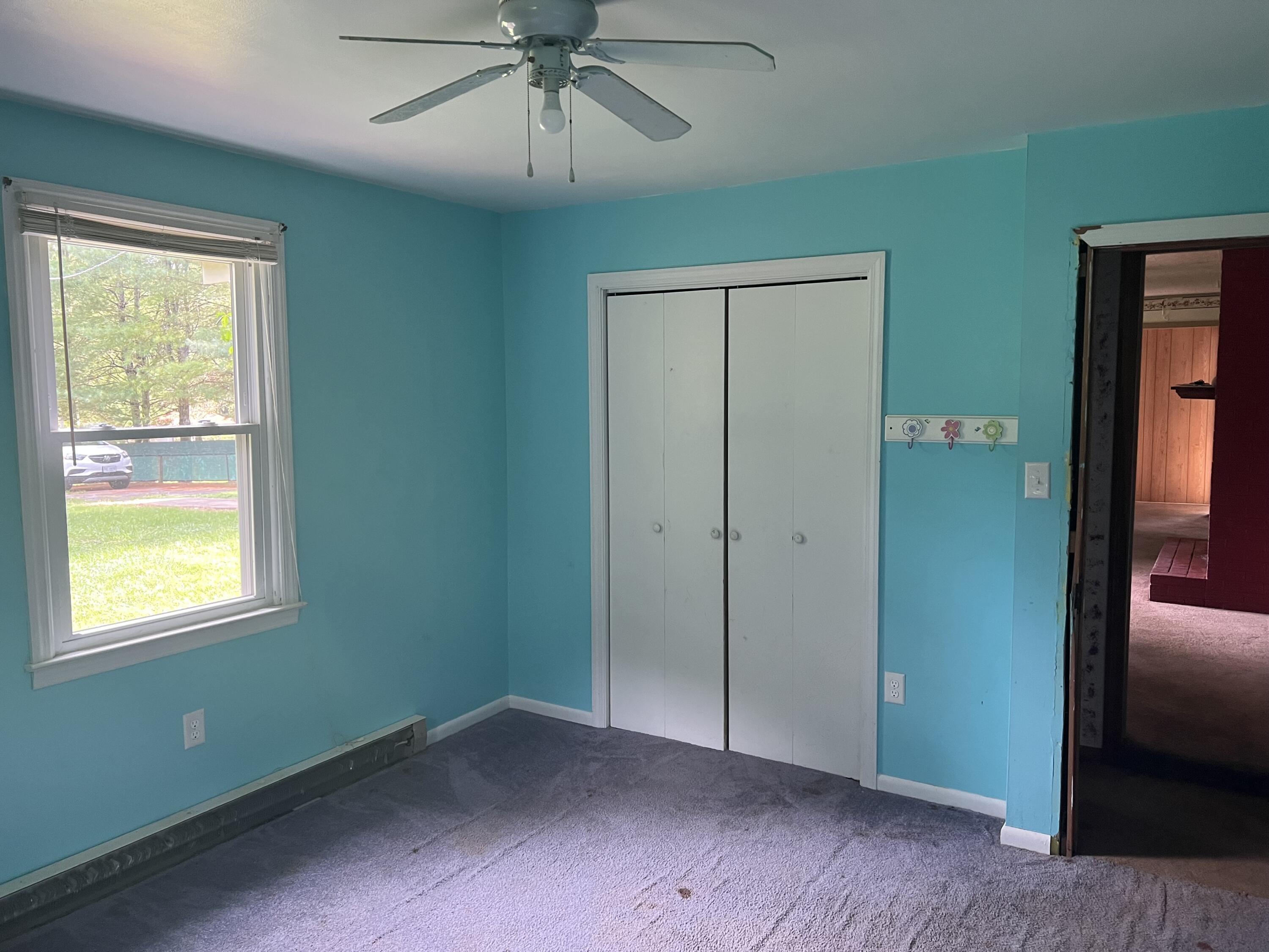 1110 Brookhaven Drive Covington, VA 24426 - Photo 8 of 11 a view of an empty room with a window and a ceiling fan