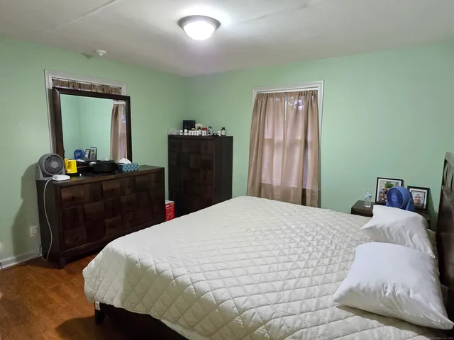 a bedroom with a bed and a dresser