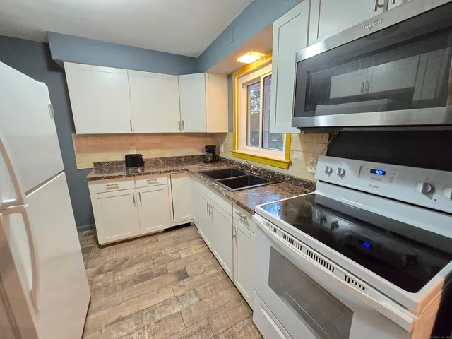 a kitchen with a stove microwave and sink