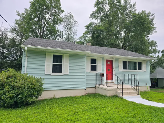 a view of a house with a yard and a garden