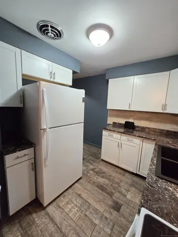 a kitchen with a refrigerator and a stove
