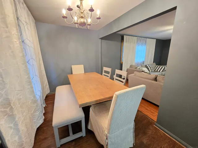 a view of a dining room with furniture and chandelier