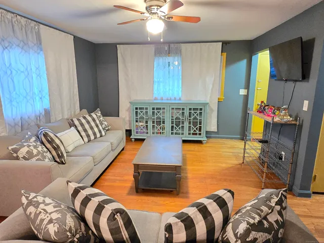 a living room with furniture and a flat screen tv