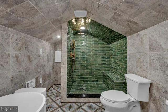 a bathroom with a toilet and shower
