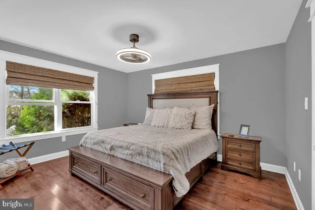 a bedroom with a bed and a large window