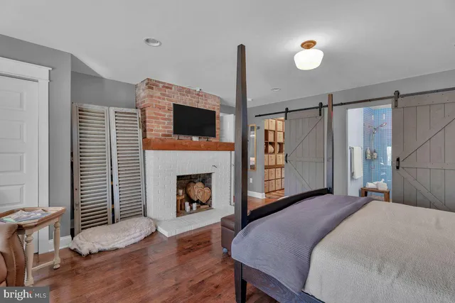 a bedroom with a bed and a fireplace