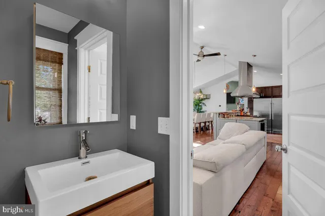 a en suite bathroom with a sink a mirror and a bathtub