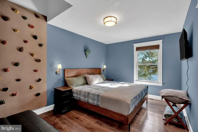 a bedroom with a bed and a window