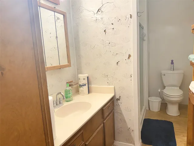 a bathroom with a sink toilet and shower