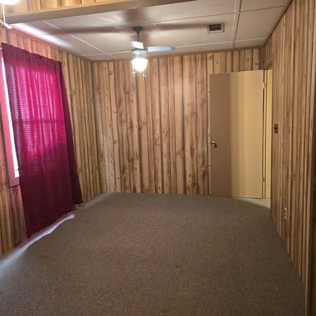 a view of a room with a curtain and door