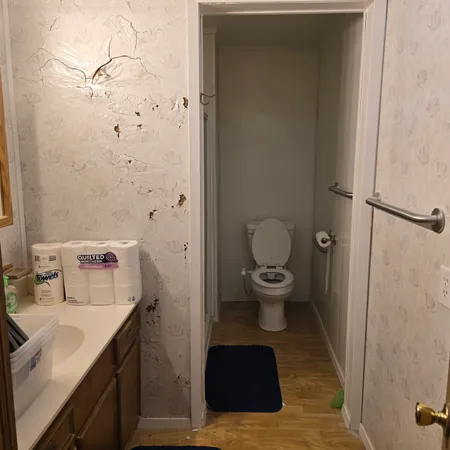 a bathroom with a sink toilet and shower
