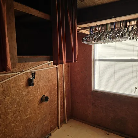 a view of a bathroom with a shower and a window