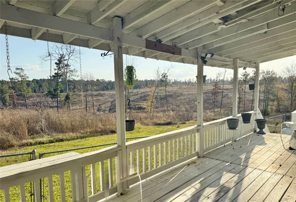 a view of a balcony with mountain view and wooden floor