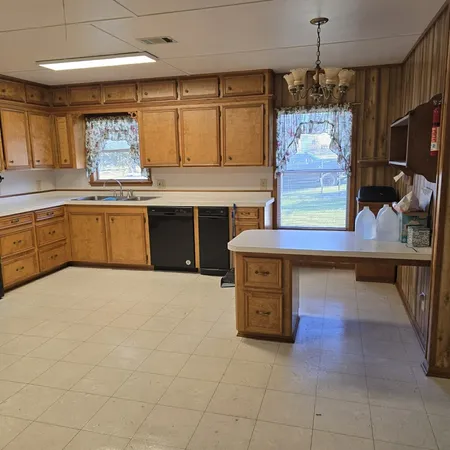 a kitchen with stainless steel appliances kitchen island granite countertop a stove a sink and a microwave