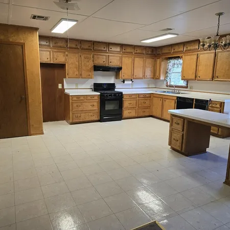 a kitchen with stainless steel appliances granite countertop a refrigerator and a stove