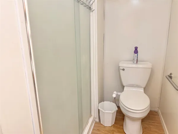 a white toilet sitting next to a white sink