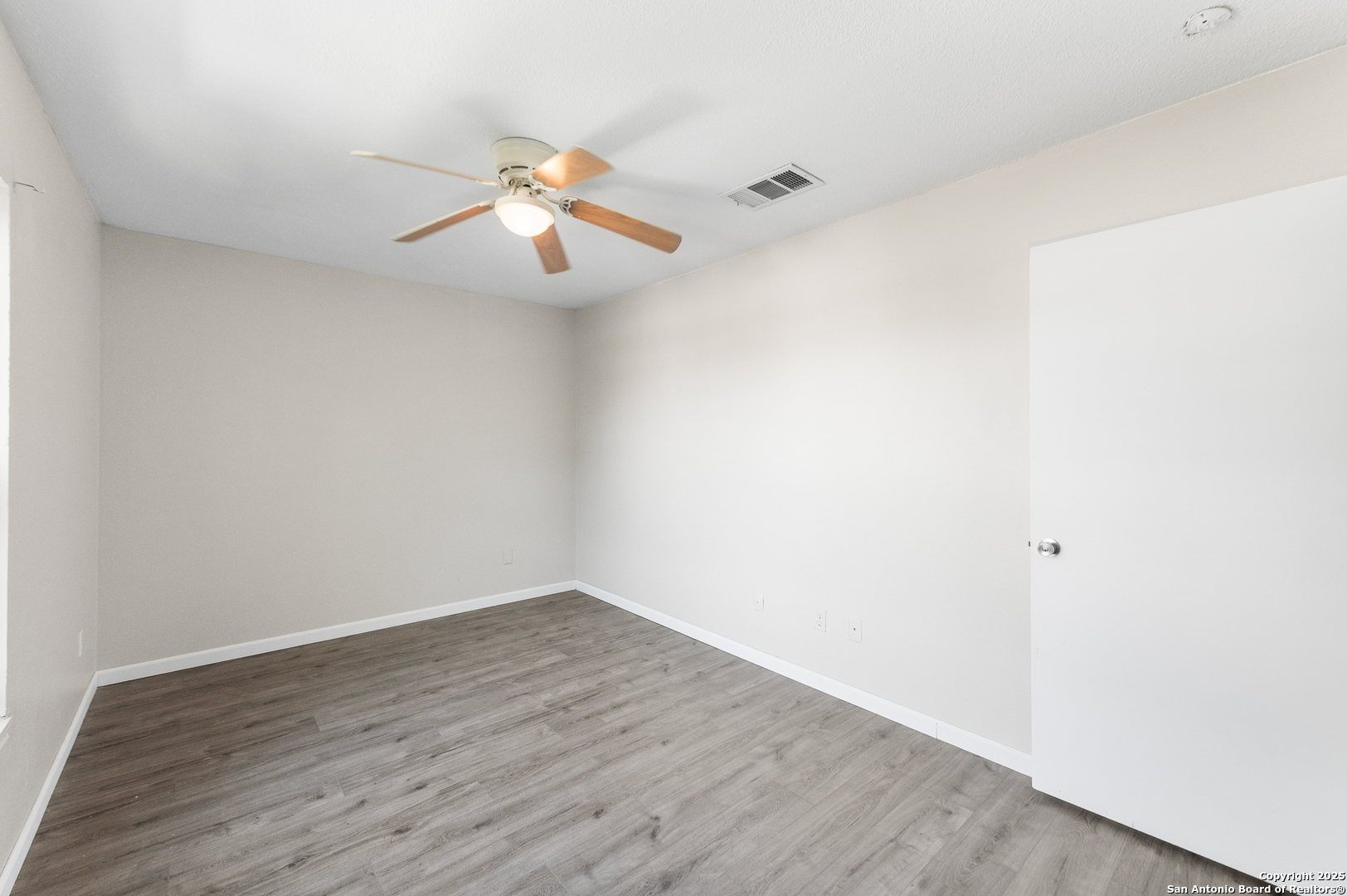 8010 Chestnut Gate Drive Converse, TX 78109 - Photo 14 of 37 a view of an empty room with wooden floor