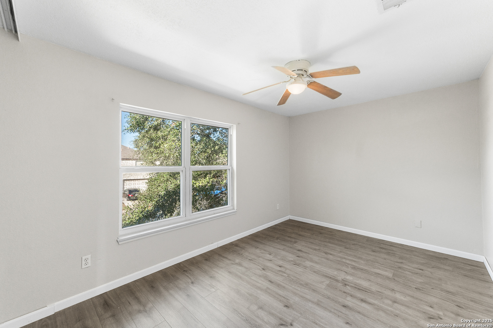 8010 Chestnut Gate Drive Converse, TX 78109 - Photo 15 of 37 an empty room with a window and a fan