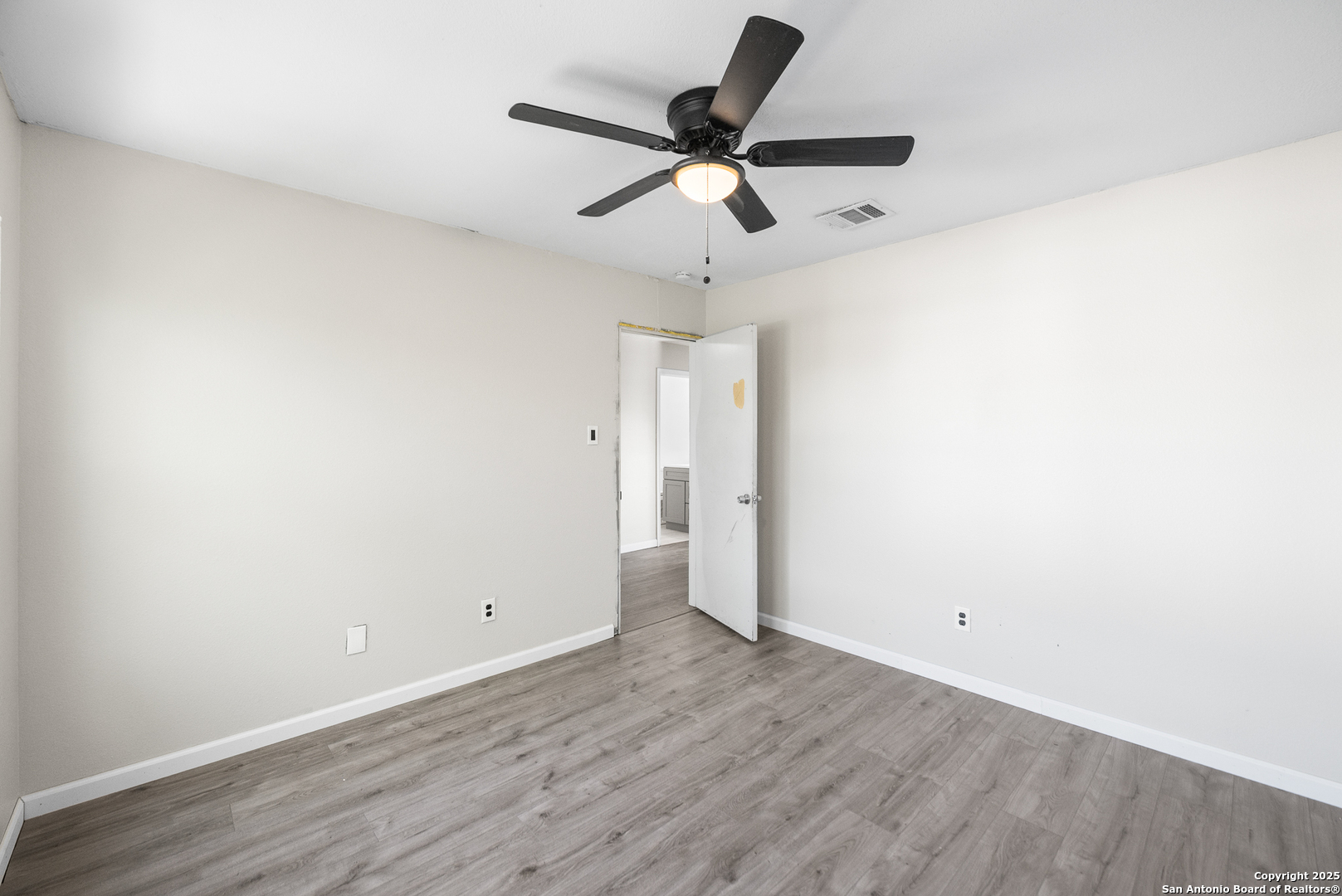8010 Chestnut Gate Drive Converse, TX 78109 - Photo 33 of 37 an empty room with wooden floor and ceiling fan