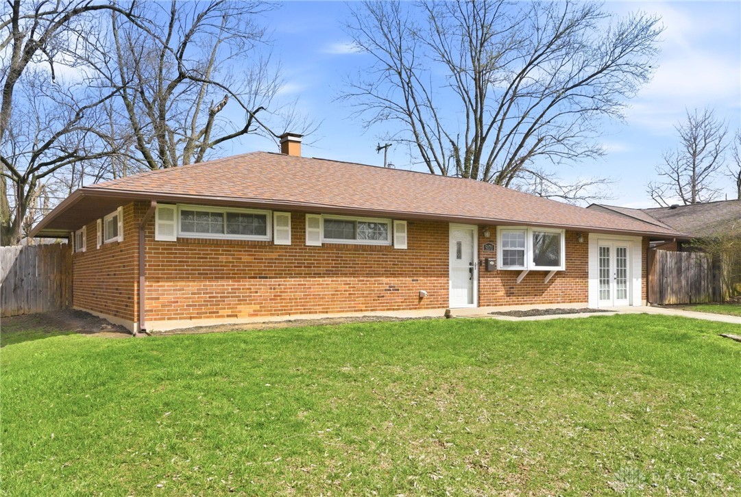 5171 Fishburg Road Dayton, OH 45424 - Photo 4 of 35 This classic brick residence features a durable roof and manicured lawn.