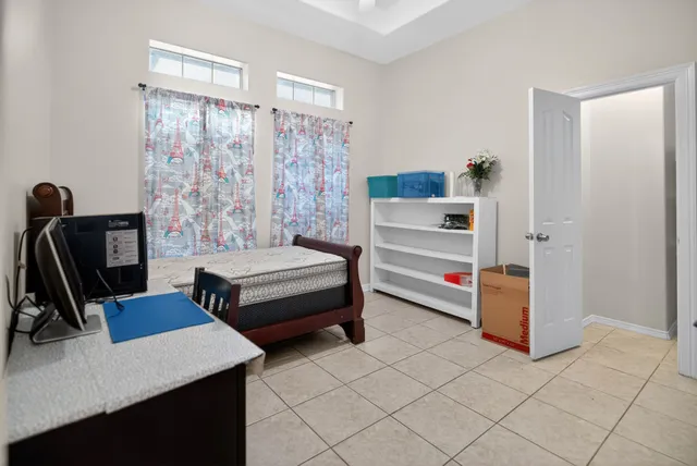 a bedroom with bed and a flat screen tv