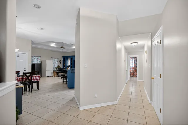 a view of a livingroom with an empty space and a hallway