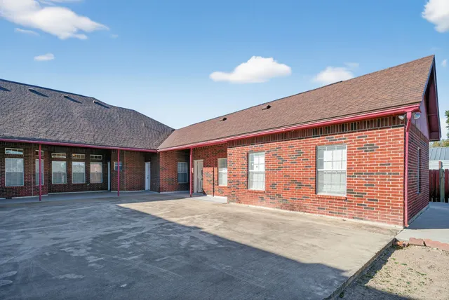 a spacious bedroom with a large bed and a large window