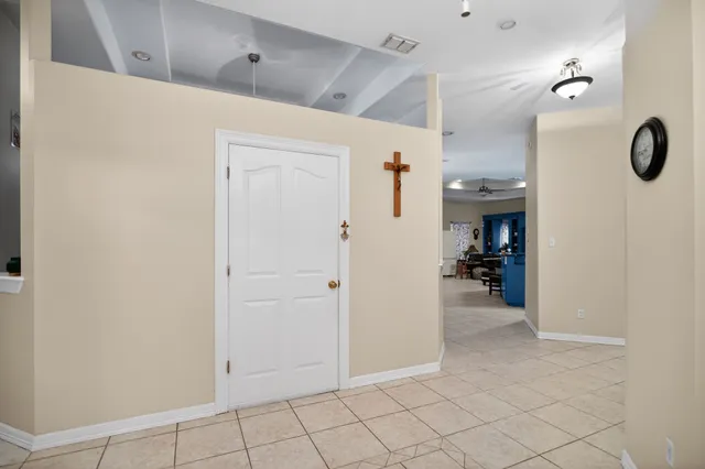 an empty room with fan and entrance