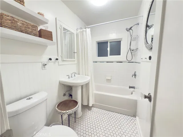 a bedroom with bed and wall painting