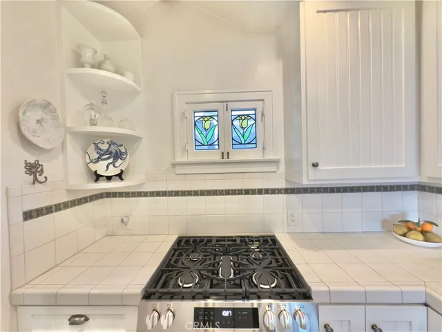 a kitchen with a stove and cabinets