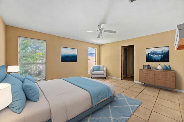 a bedroom with a large bed and a window