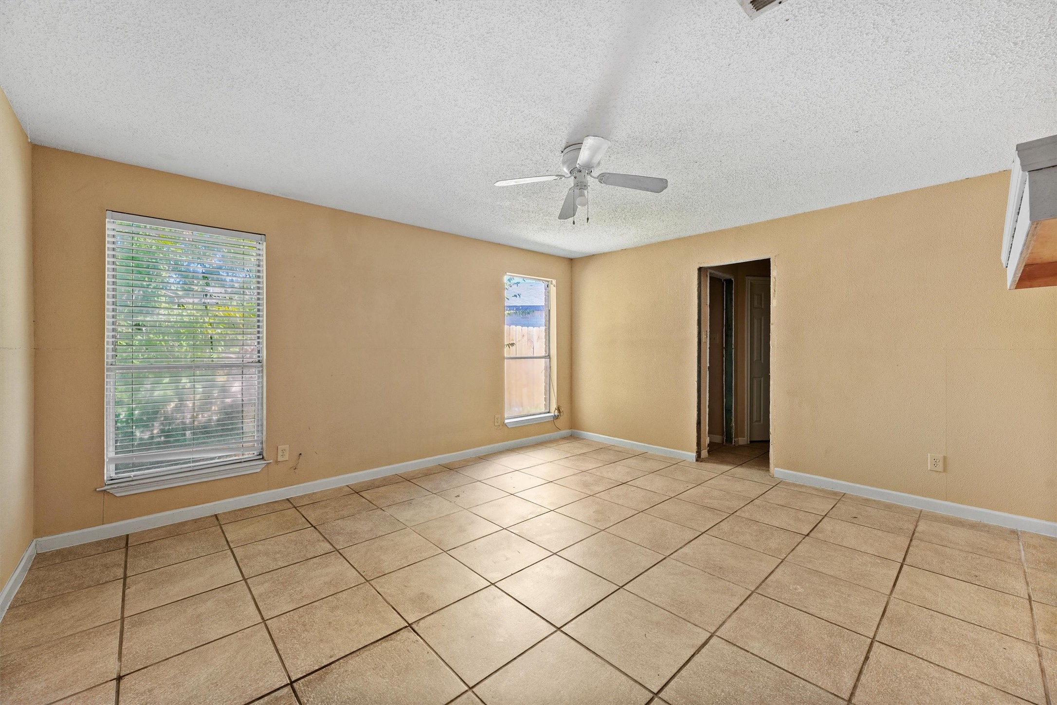 11211 Early Spring Circle Houston, TX 77064 - Photo 18 of 31 a view of an empty room with window and chandelier fan