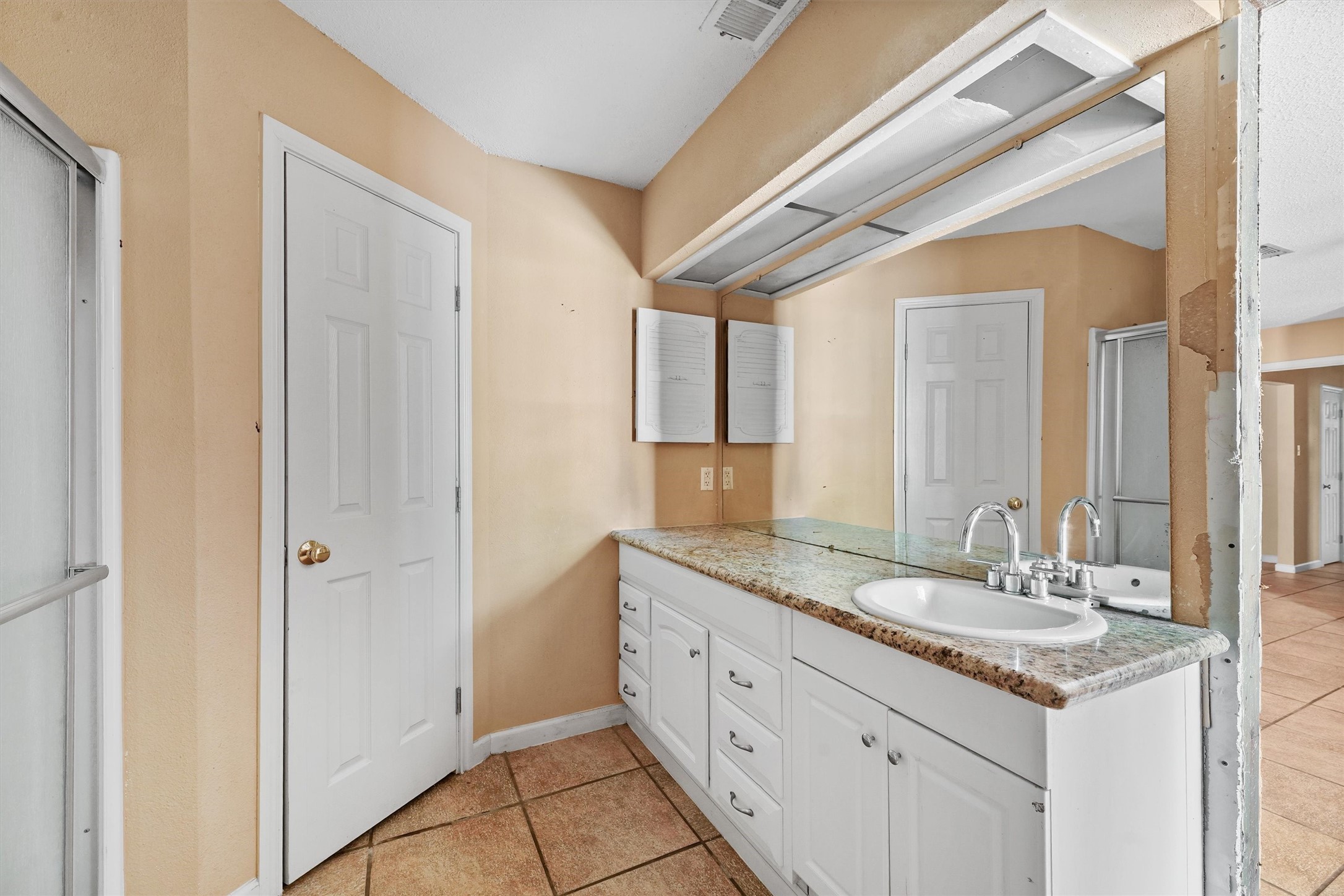 11211 Early Spring Circle Houston, TX 77064 - Photo 20 of 31 a bathroom with a granite countertop sink and a mirror
