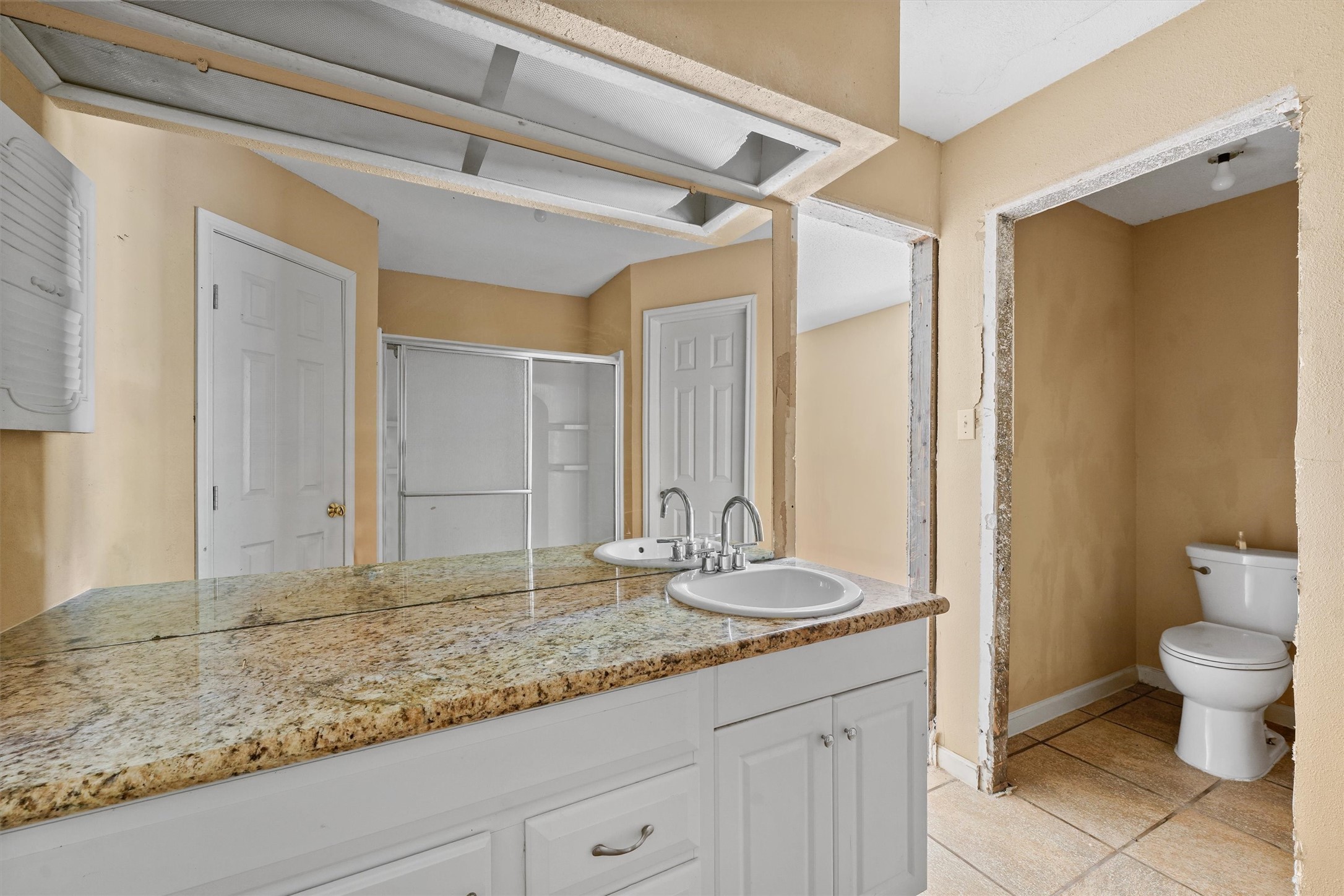 11211 Early Spring Circle Houston, TX 77064 - Photo 21 of 31 a bathroom with a granite countertop sink and a mirror