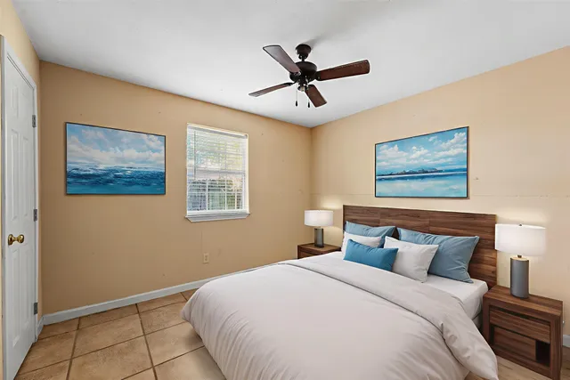 a bedroom with a large bed and a window