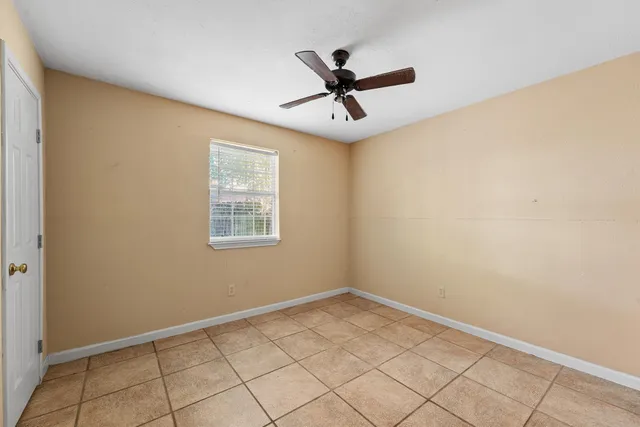 a view of a big room with wooden floor and windows in a room