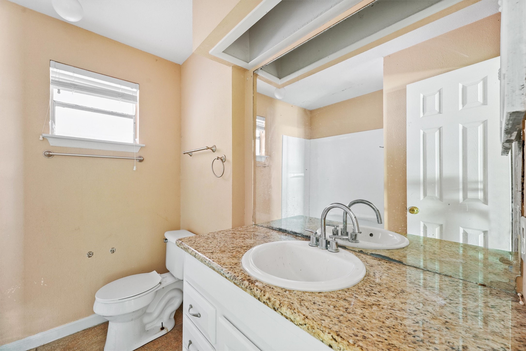 11211 Early Spring Circle Houston, TX 77064 - Photo 24 of 31 a bathroom with a granite countertop toilet a sink and a mirror