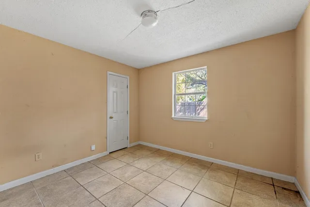 a bedroom with a bed and a potted plant