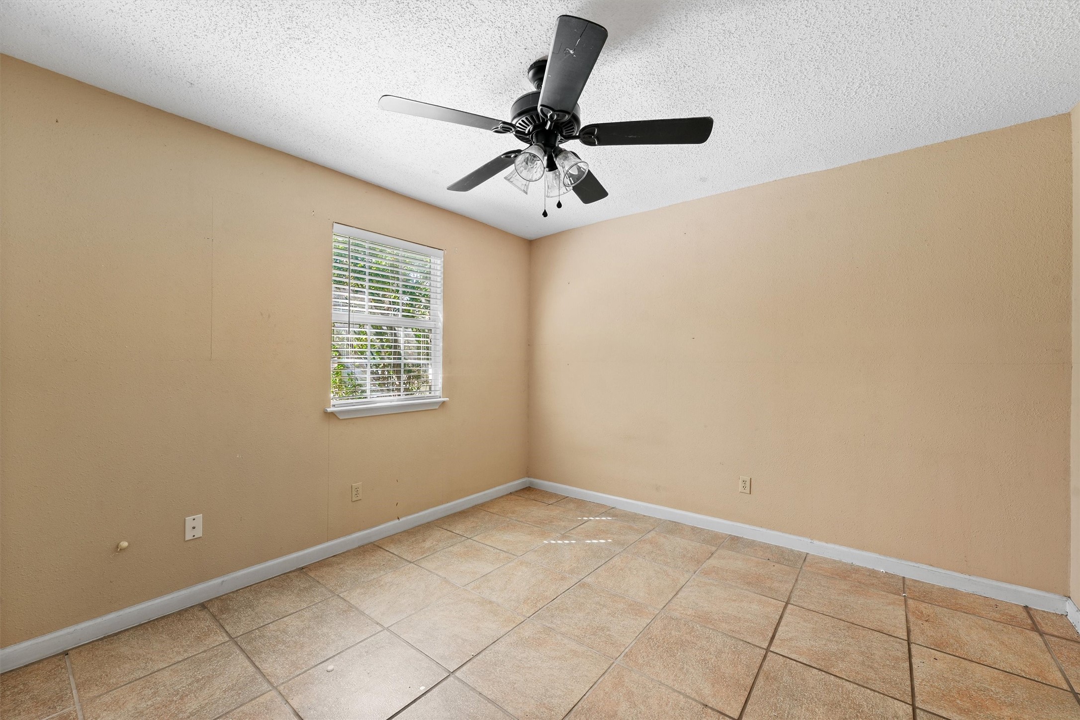 11211 Early Spring Circle Houston, TX 77064 - Photo 28 of 31 an empty room with a window and a fan