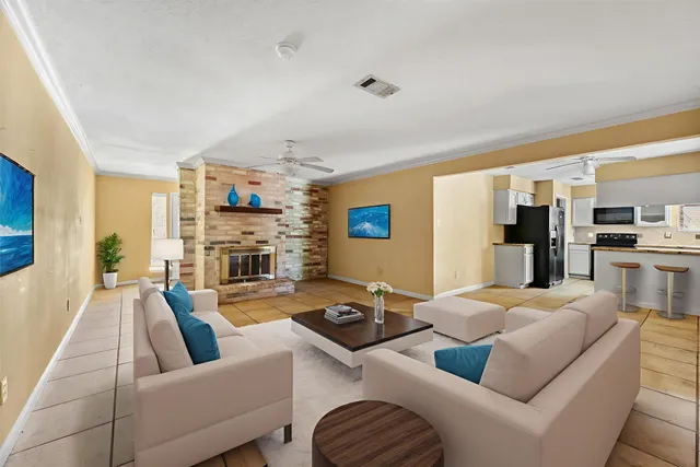 a living room with furniture fireplace and flat screen tv