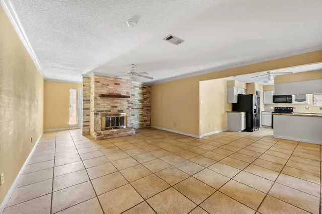 a view of a electric appliances in kitchen and empty room with kitchen