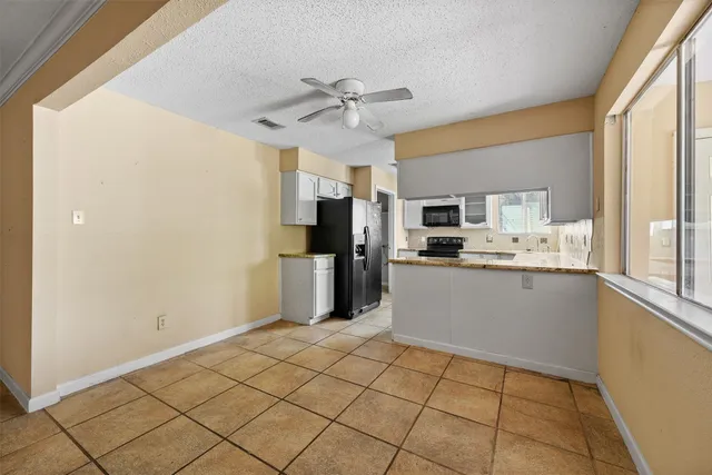 a kitchen with stainless steel appliances a refrigerator sink and microwave