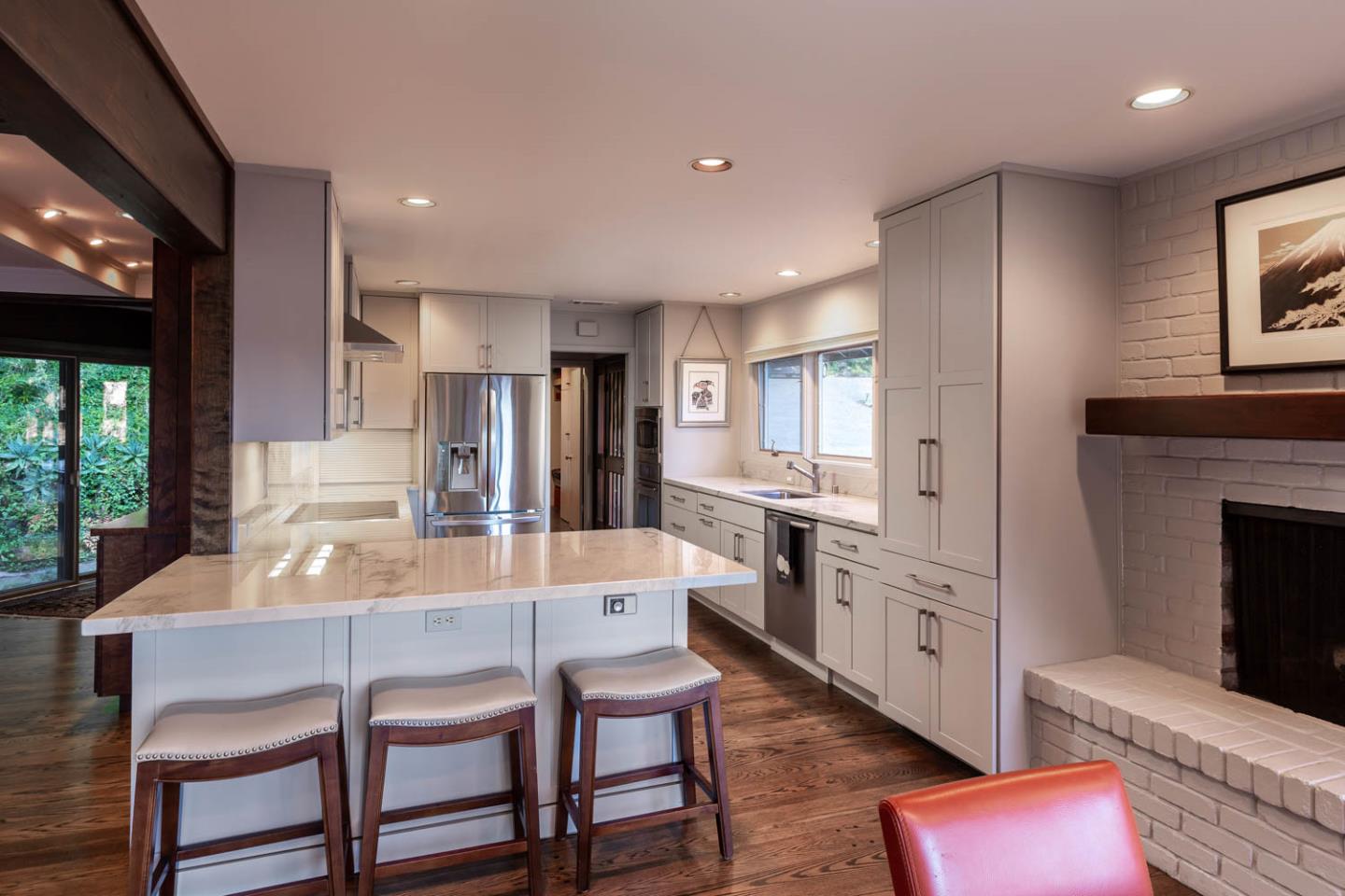 1255 La Honda Road Woodside, CA 94062 - Photo 8 of 26 a large kitchen with stainless steel appliances kitchen island granite countertop a dining table chairs and a refrigerator