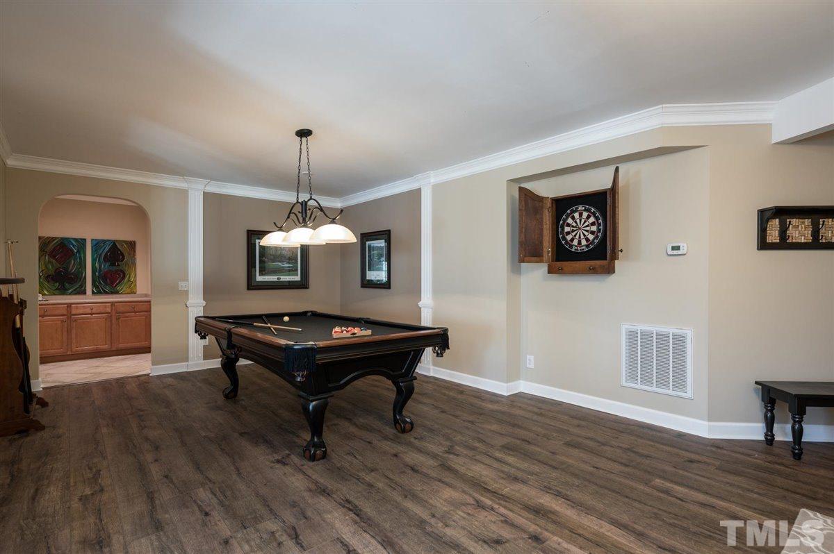 3100 Pyxis Court Raleigh, NC 27614 - Photo 16 of 30 Luxury vinyl plank flooring throughout the main areas of the basement. There's an additional snack bar and storage area that flanks this space.