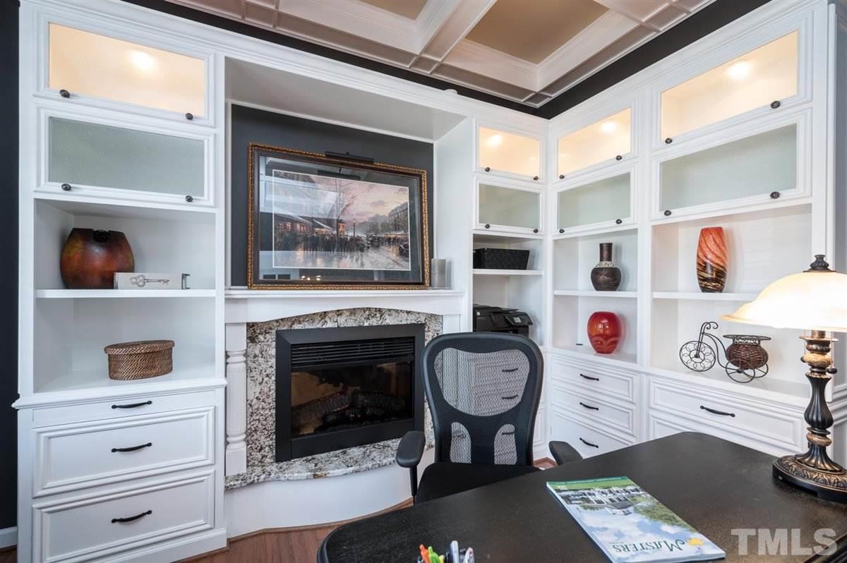 3100 Pyxis Court Raleigh, NC 27614 - Photo 9 of 30 Custom built-in drawers, storage cabinets, and a cozy fireplace.
