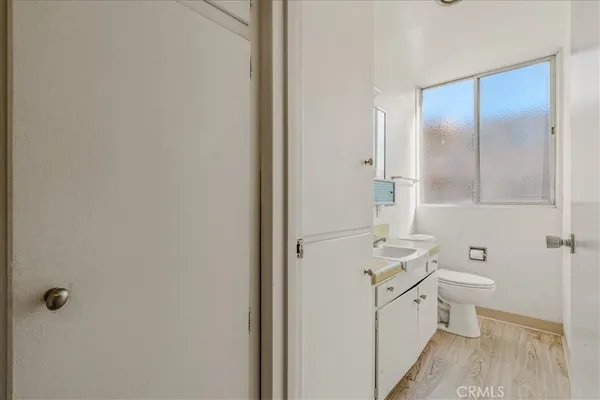 a bathroom with a granite countertop sink a toilet and shower