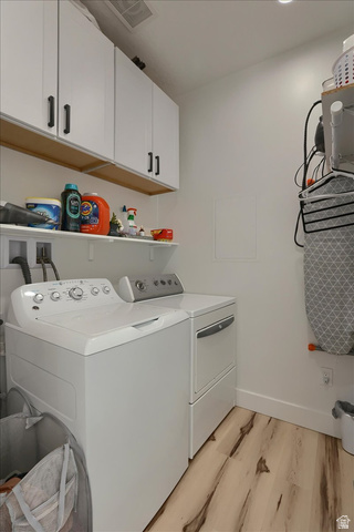 828 South Deer Road Tooele, UT 84074 - Photo 24 of 51 Dedicated laundry area featuring white appliances, upper white cabinetry with dark hardware, a wall-mounted shelving unit, and wood-finish flooring